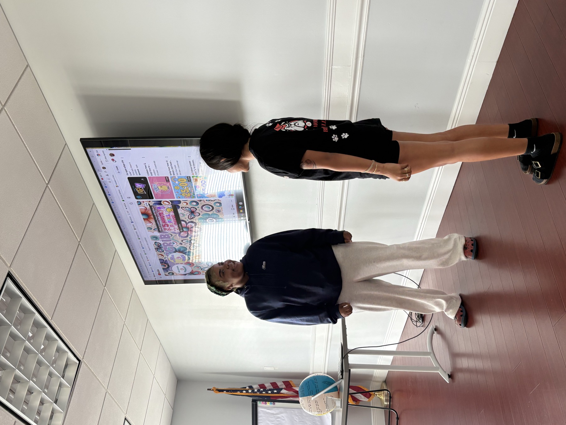 Two volunteers talking in front of a screen during a workshop session